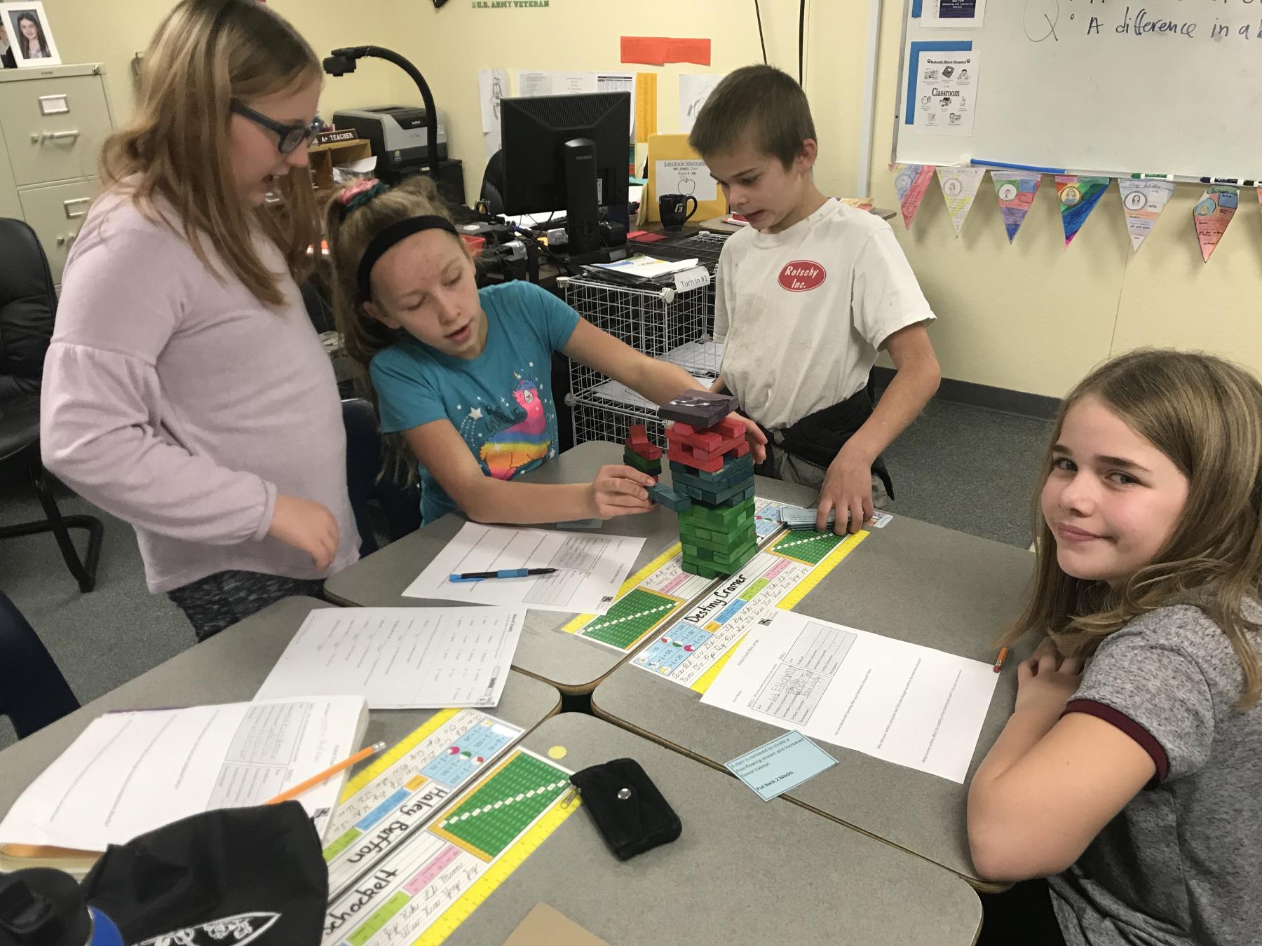 Four students collaborate on a science activity