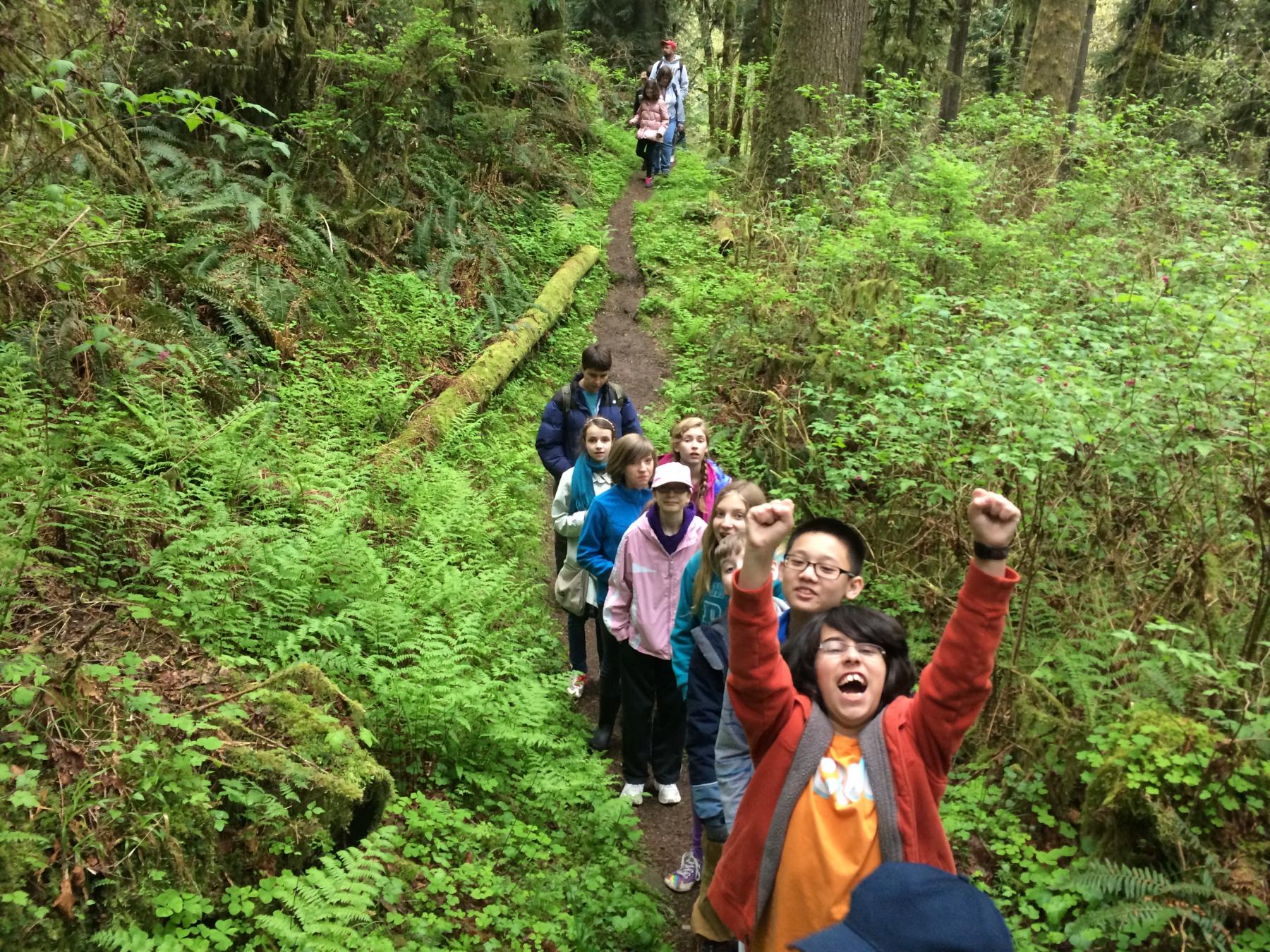 students hiking in forest
