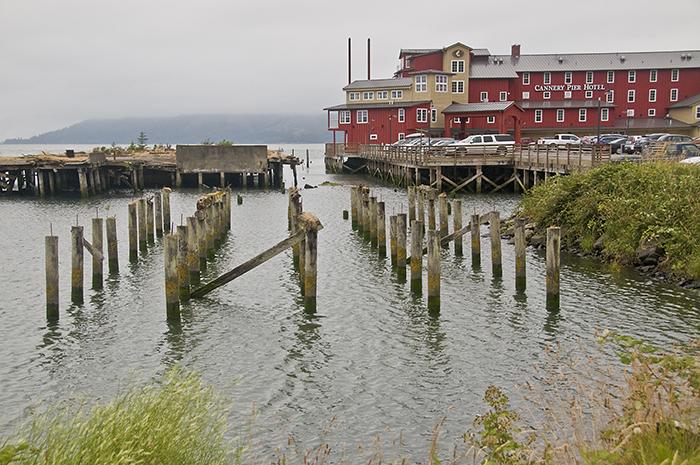 The swanky Cannery Pier Hotel stands near a derelict building on pilings