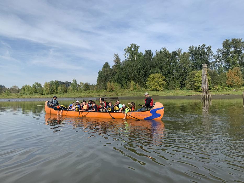 A Big Canoe of students paddle on Scappoose Bay