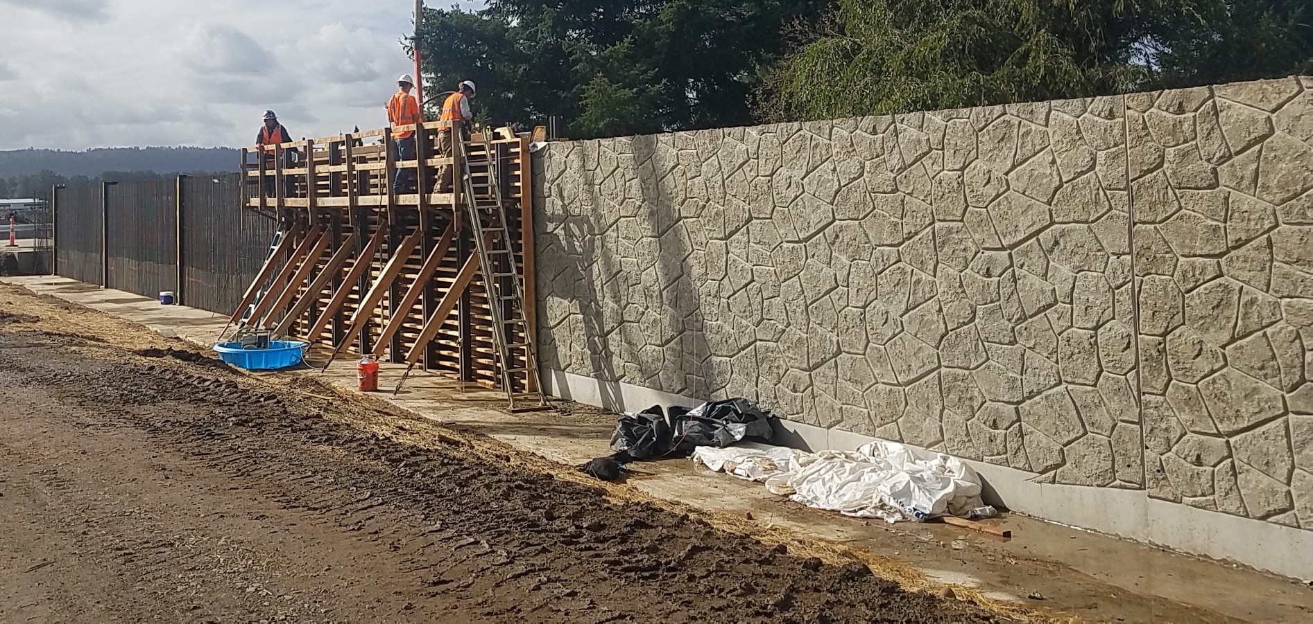 workers construct a flood wall