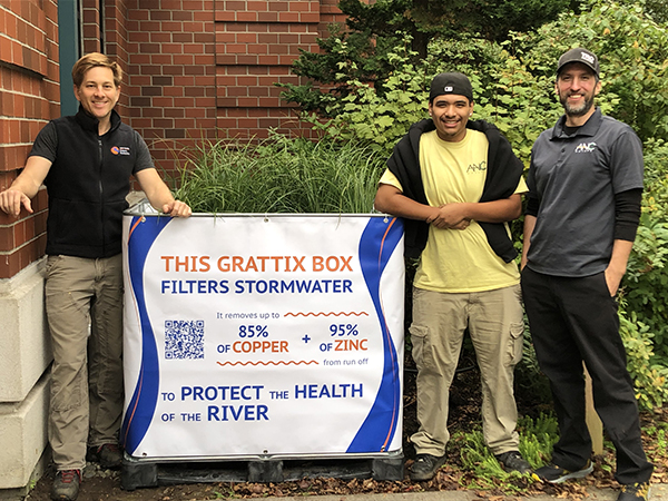 three men pose with a Grattix