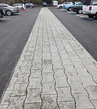 permeable pavers run through the middle of a parking lot