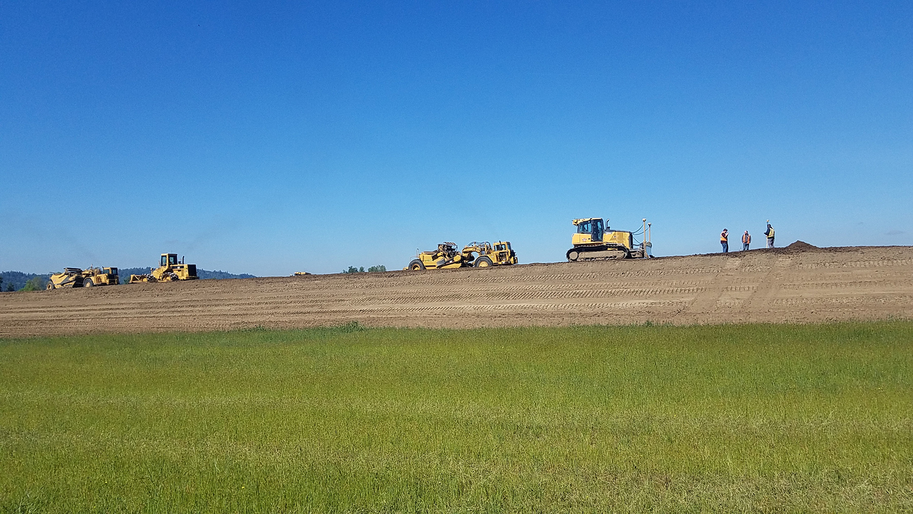 large equipment on top of a levee