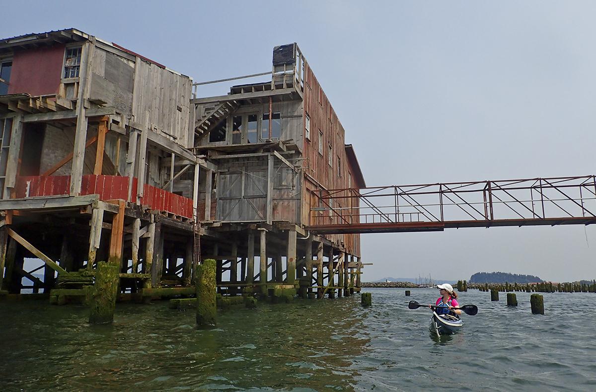 Kayaking by an old building in Astoria