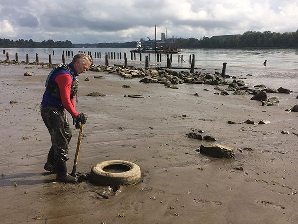 Chris Hathaway pries a tire from the mud.