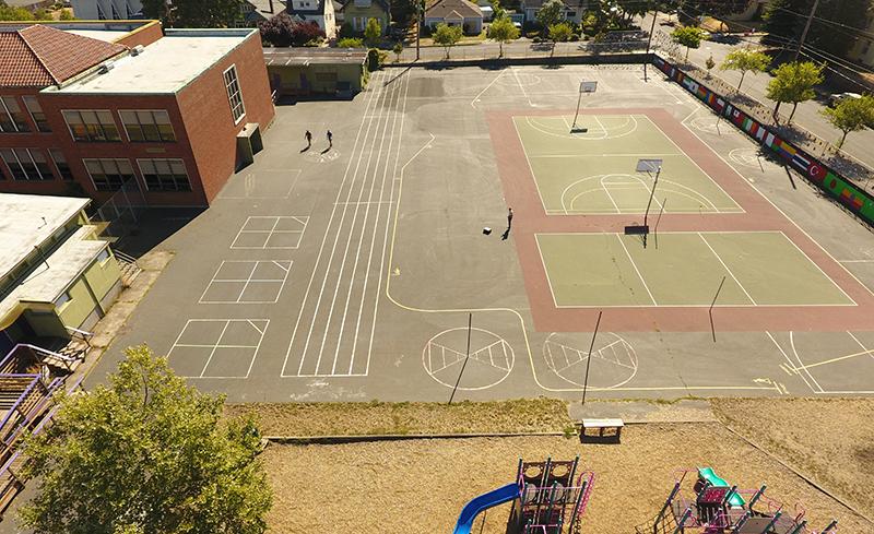 aerial of the Vernon playground before showing a large paved playground