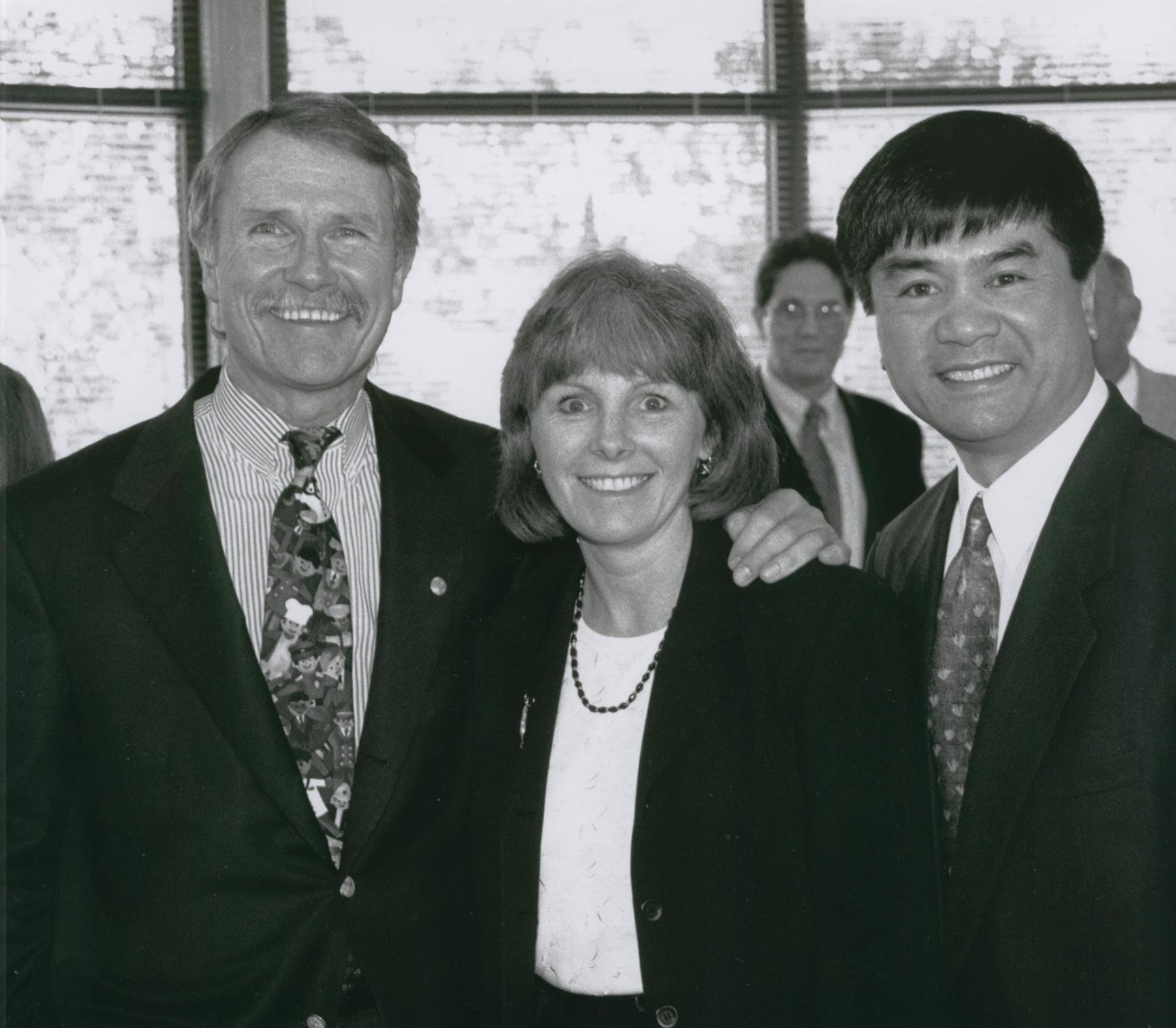 Black and white photo of the group smiling