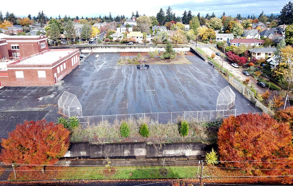 aerial view of the large schoolyard that is almost all asphalt 