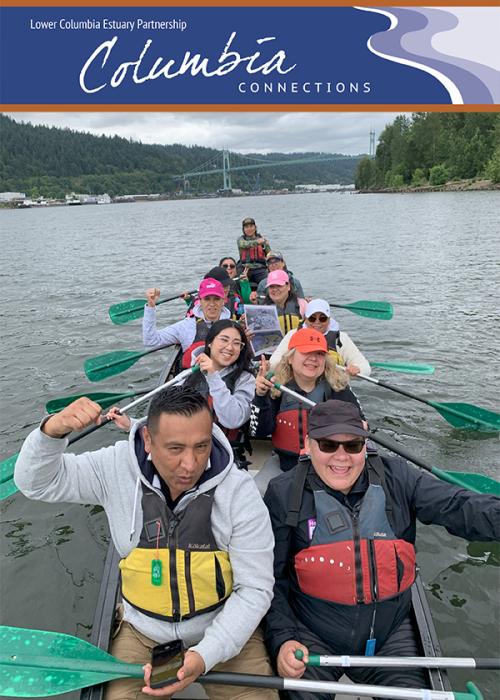 a group of people smile while paddling a Big Canoe