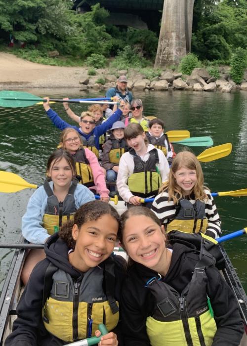 happy students in a Big Canoe